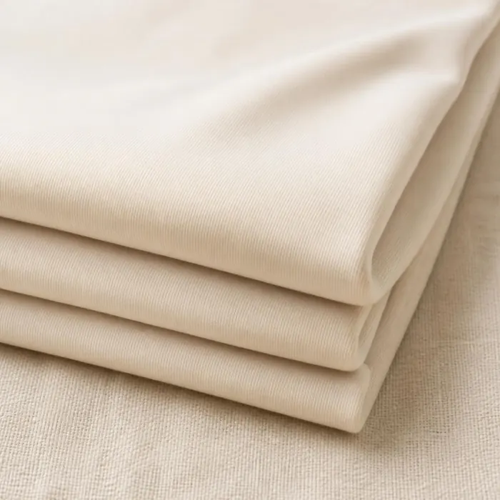 Folded cream ProCool Performance Interlock jersey fabric showing a soft, smooth knit texture